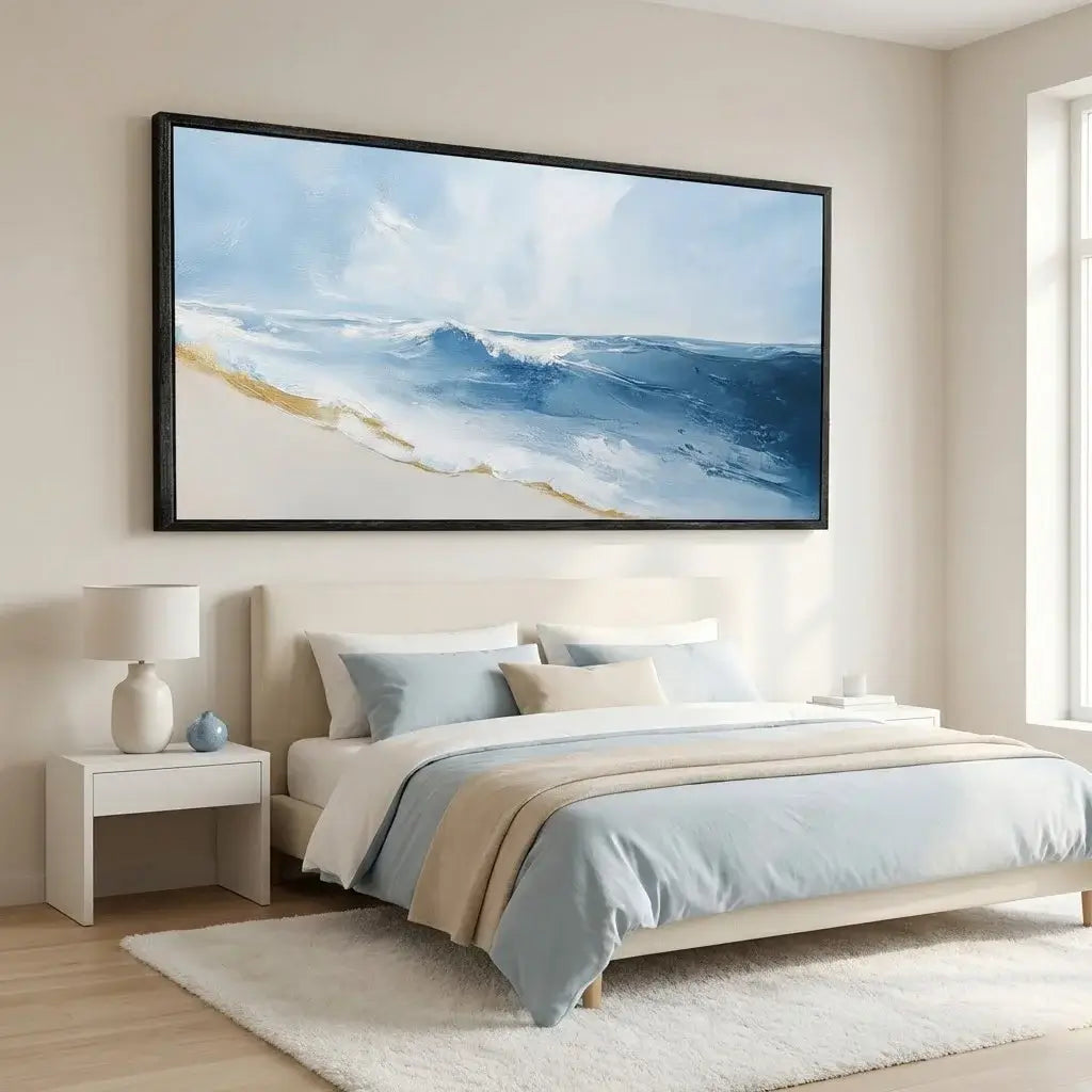 Bedroom with a large framed artwork of a beach scene on the wall.