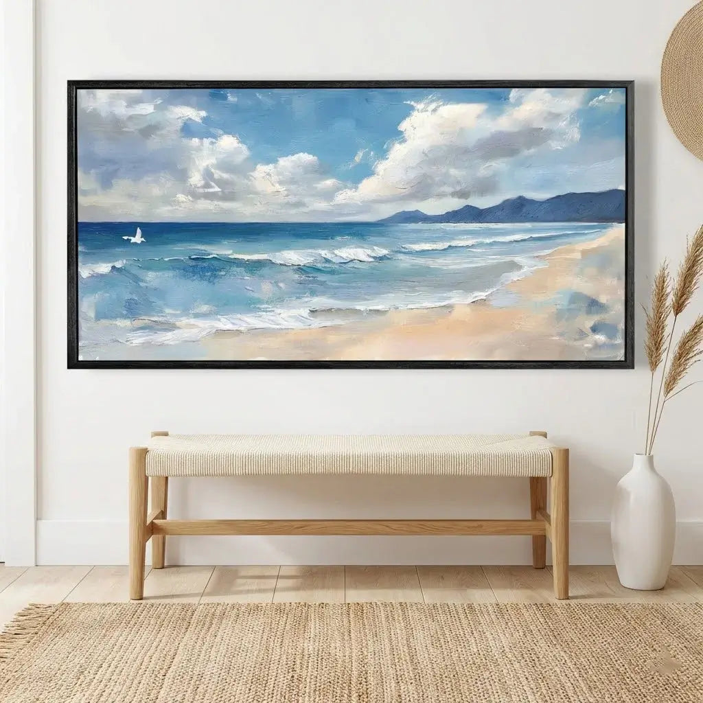 Framed beach scene painting on a wall above a bench.