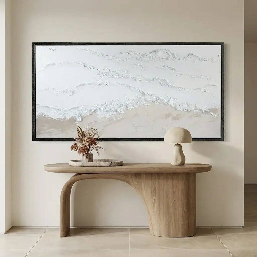 Wooden console table with decorative items against a wall with abstract art