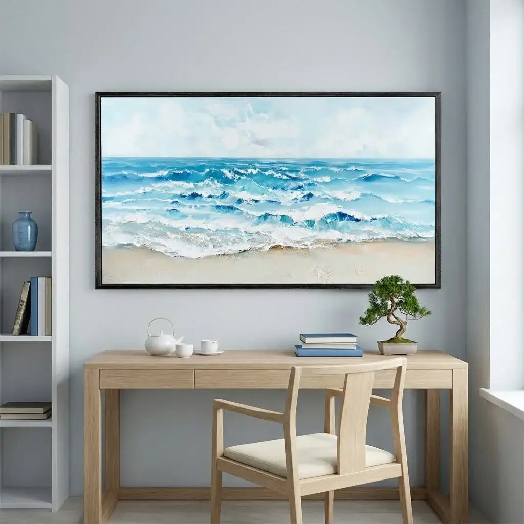 Modern office setup with a desk, chair, and wall art of an ocean scene.