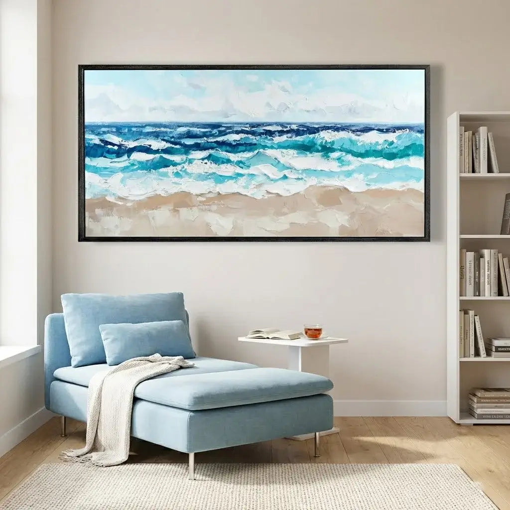Living room with a blue sofa, small table, and large ocean painting on the wall.