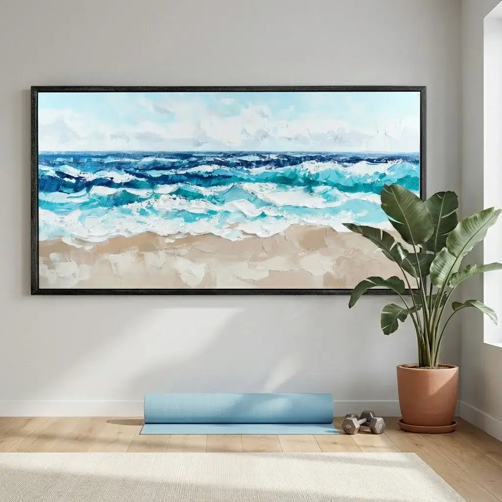 Framed beach scene painting on a wall with a plant and yoga mat below.