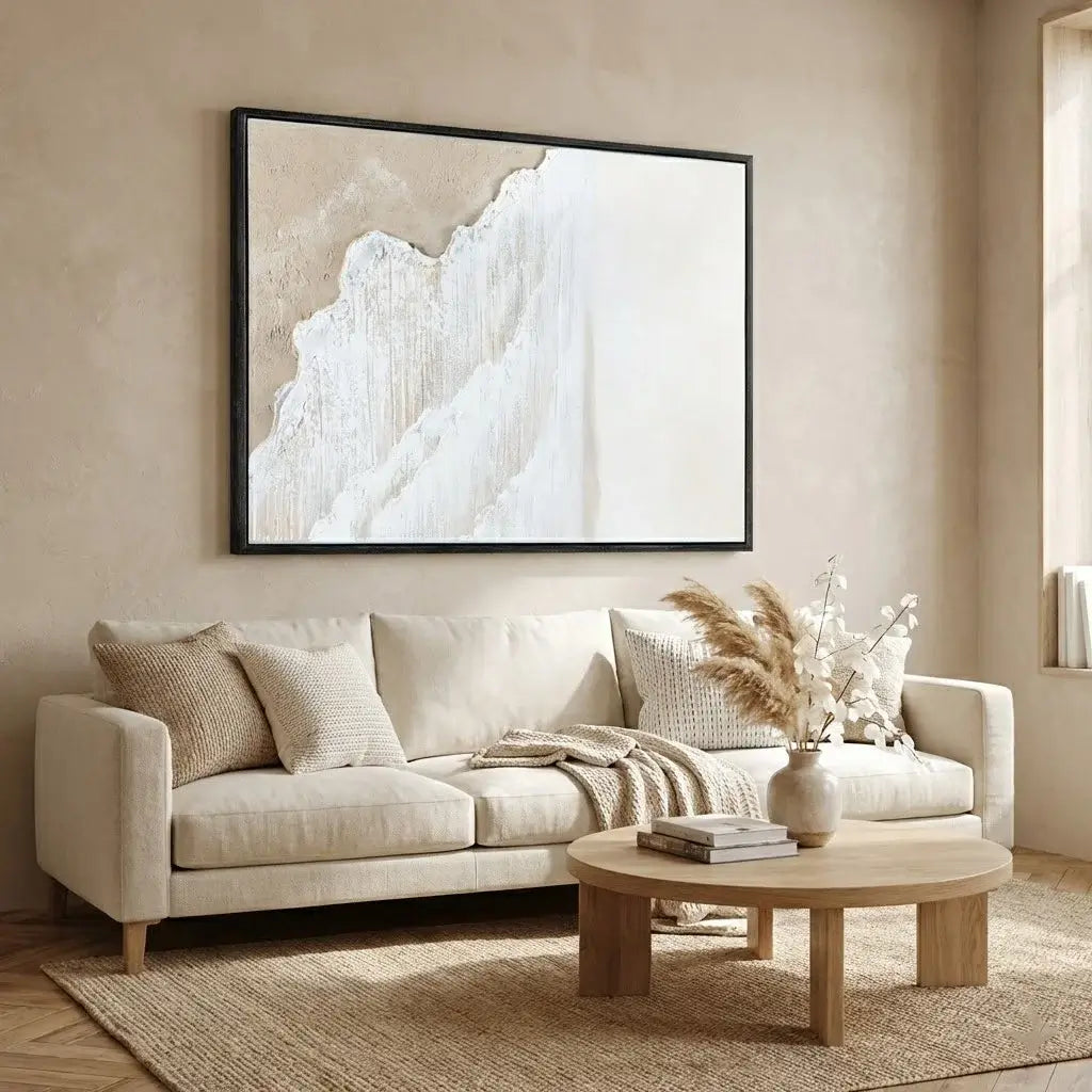 Beige living room with a sofa, coffee table, and abstract art on the wall.