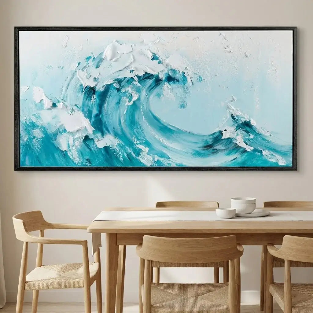 Framed abstract painting of a wave above a dining table with chairs.
