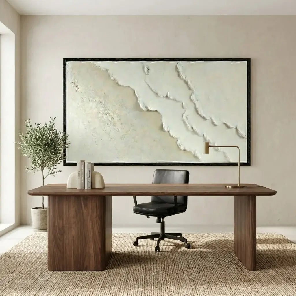 Modern office setup with a wooden desk, black chair, and abstract wall art.