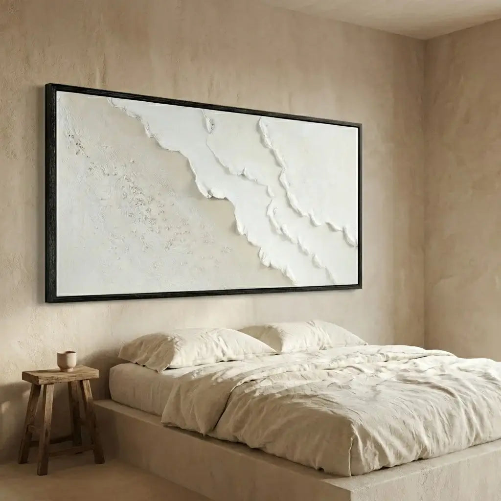 Beige bedroom with a large abstract painting above a bed