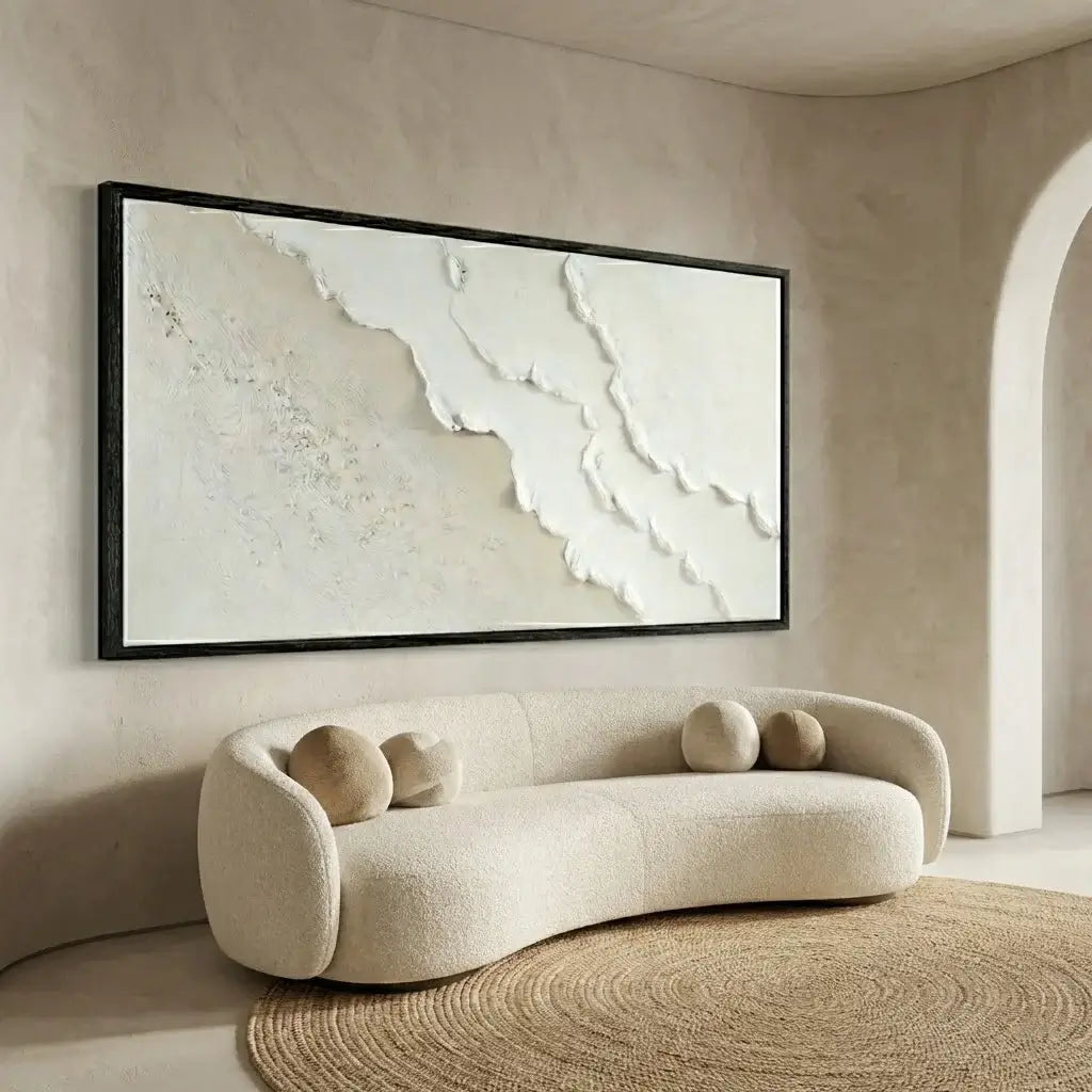 Beige sofa with spherical cushions in a room with a large abstract painting on the wall.