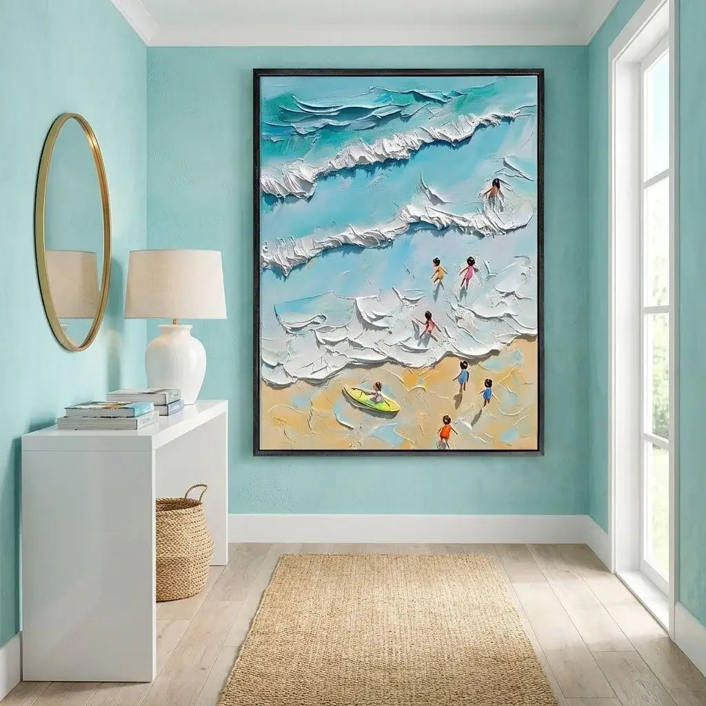 Framed artwork of children playing on a beach with waves in a room with light blue walls.