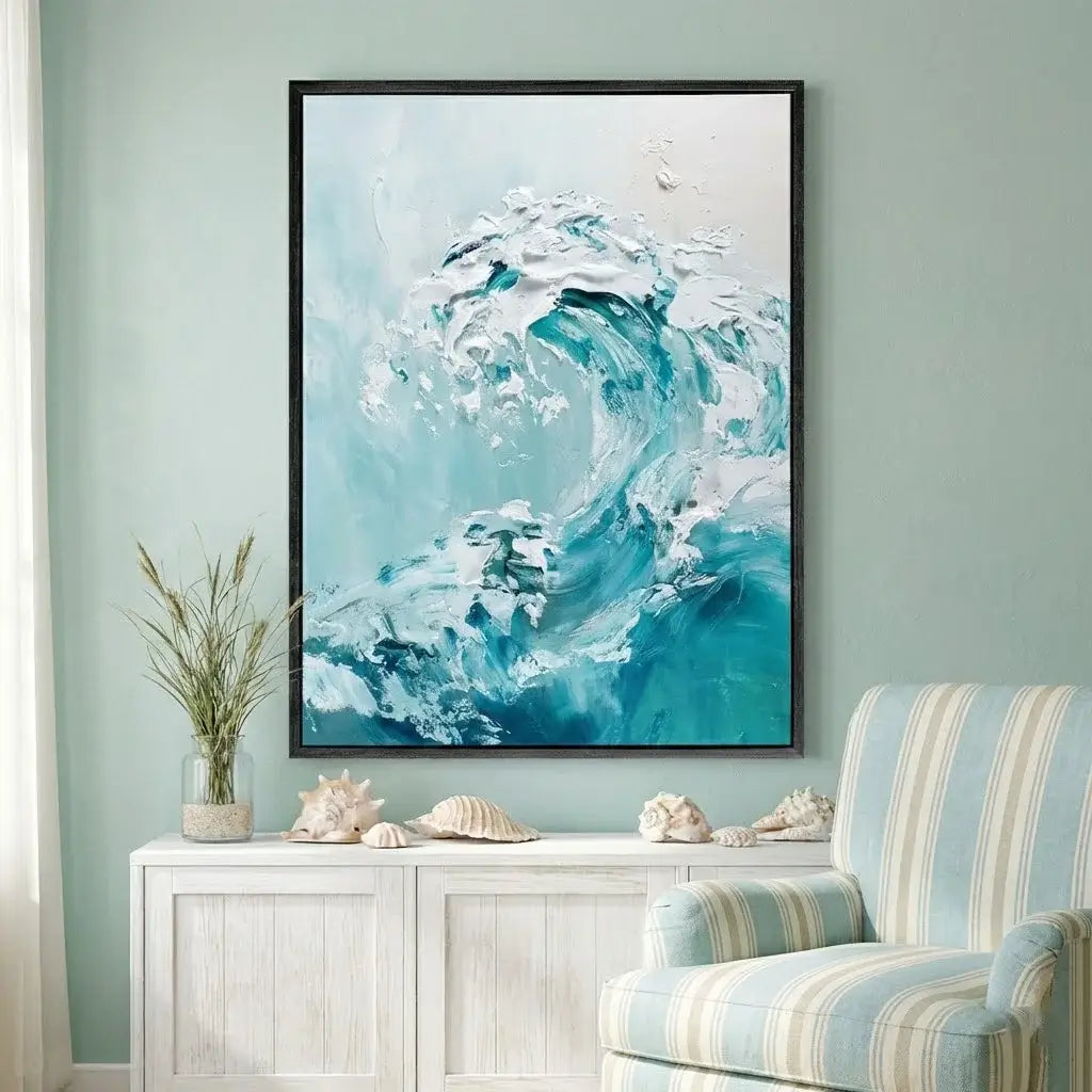 Framed abstract ocean wave painting on a wall above a white cabinet with decorative shells.