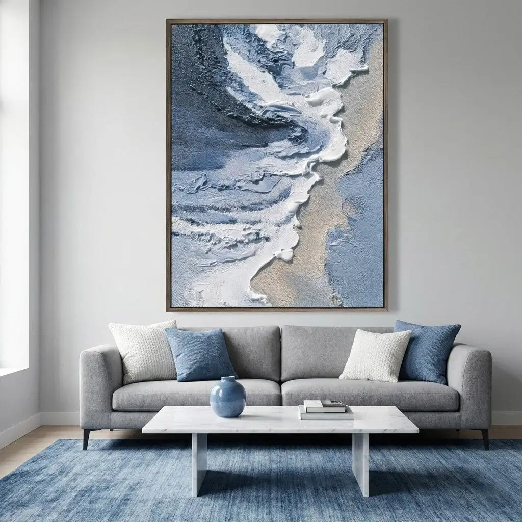 Living room with a gray sofa, blue rug, and abstract art on the wall.