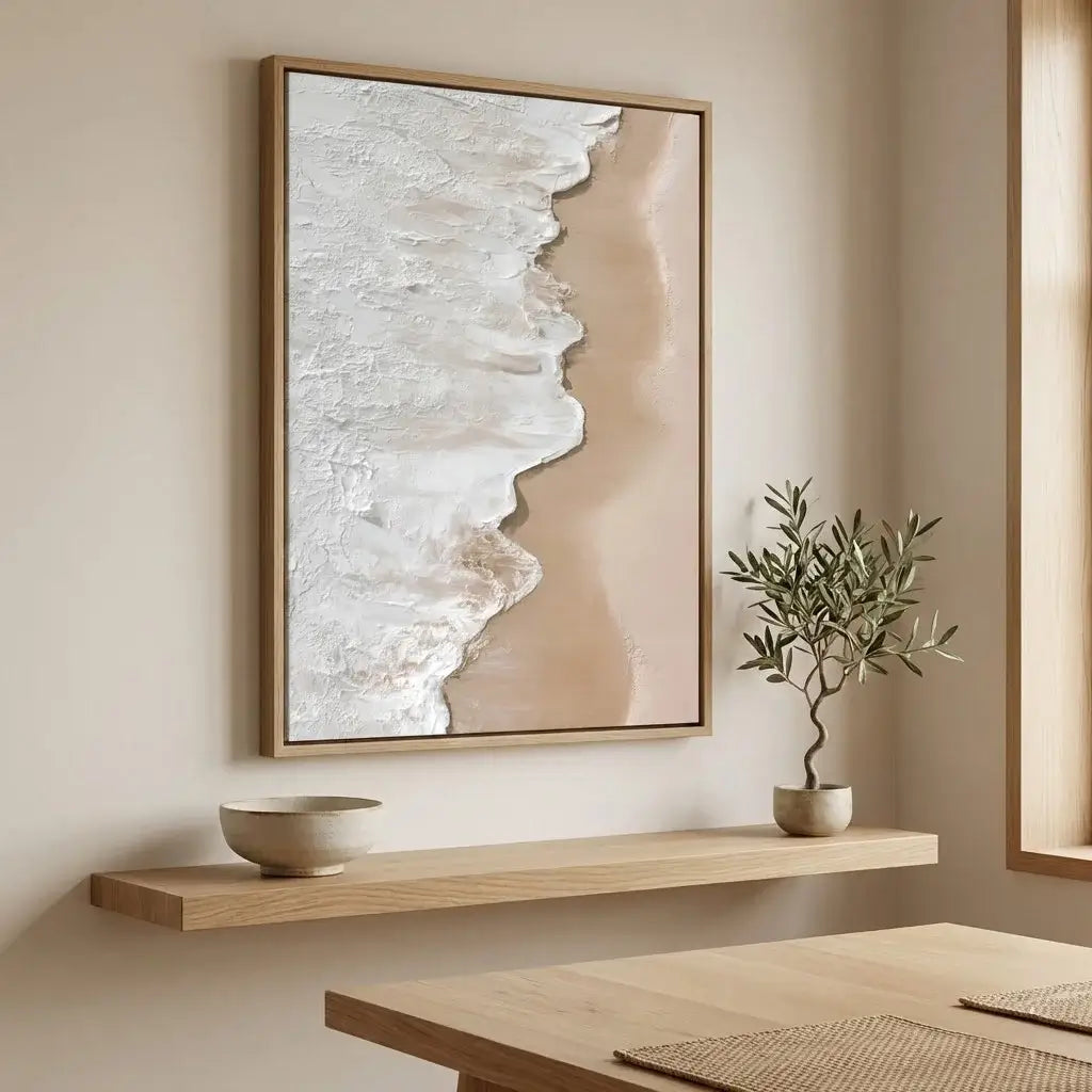 Abstract art piece on a wall above a wooden shelf with a plant and bowl.