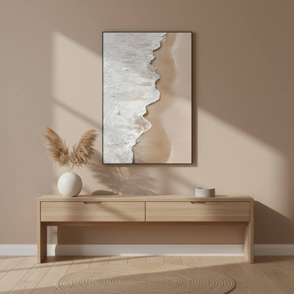 Beige wall with a framed abstract artwork above a wooden console table.