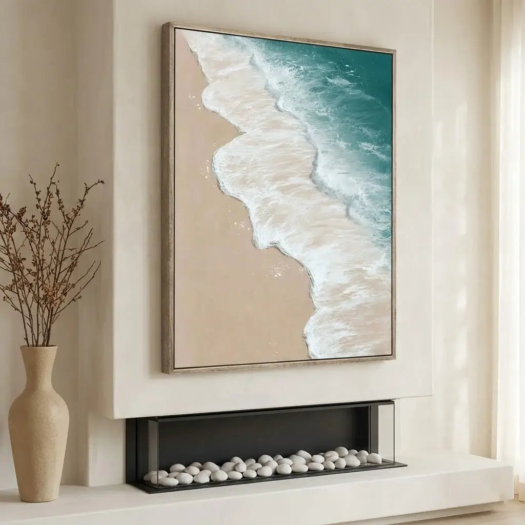 Framed artwork of a beach scene above a fireplace with decorative elements.