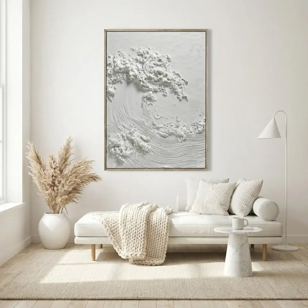 Modern living room with a white sofa, decorative pillows, and a framed artwork on the wall.