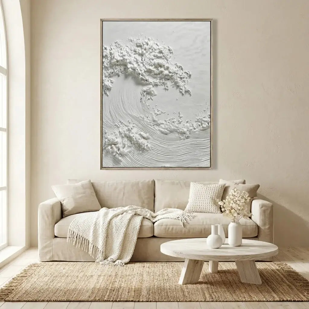 Living room with a beige sofa, round coffee table, and abstract wall art.