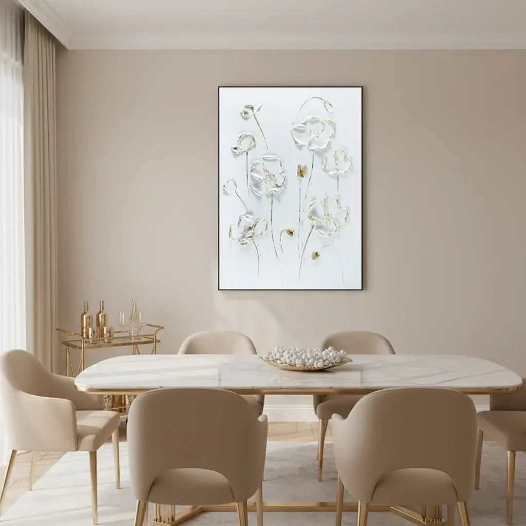 Dining room with a beige table and chairs, gold accents, and a floral painting on the wall.