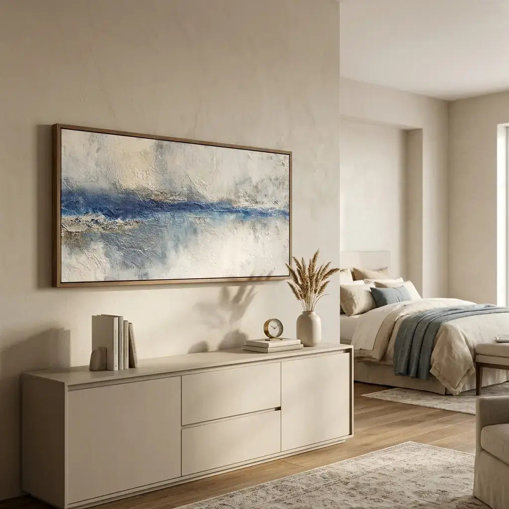 Modern bedroom with abstract painting, sideboard, and bed.
