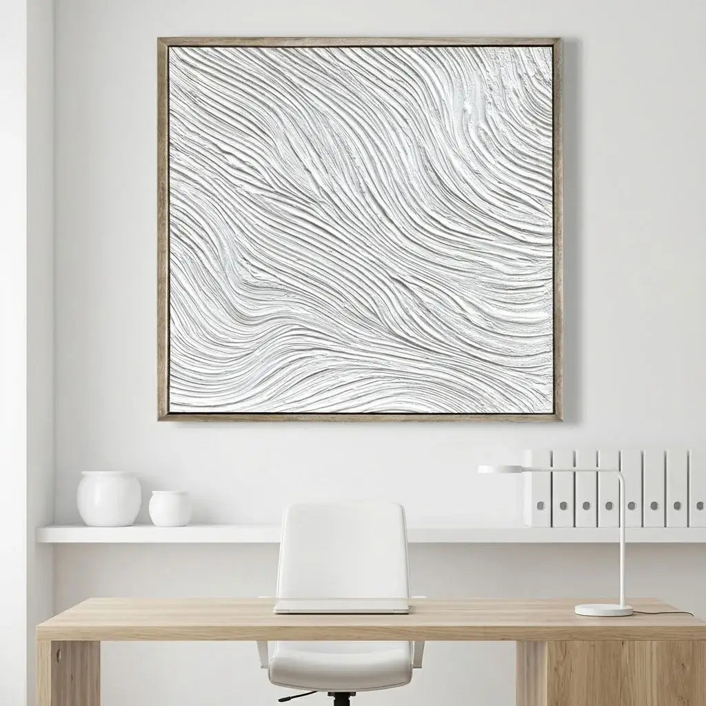 Framed abstract artwork above a desk in a minimalistic office setting