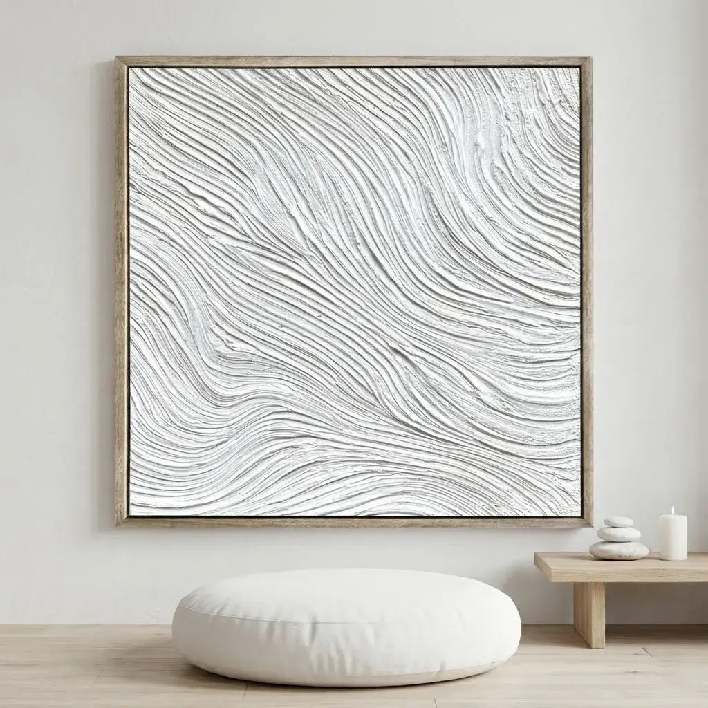 Abstract wall art with wavy lines in a wooden frame on a white wall.