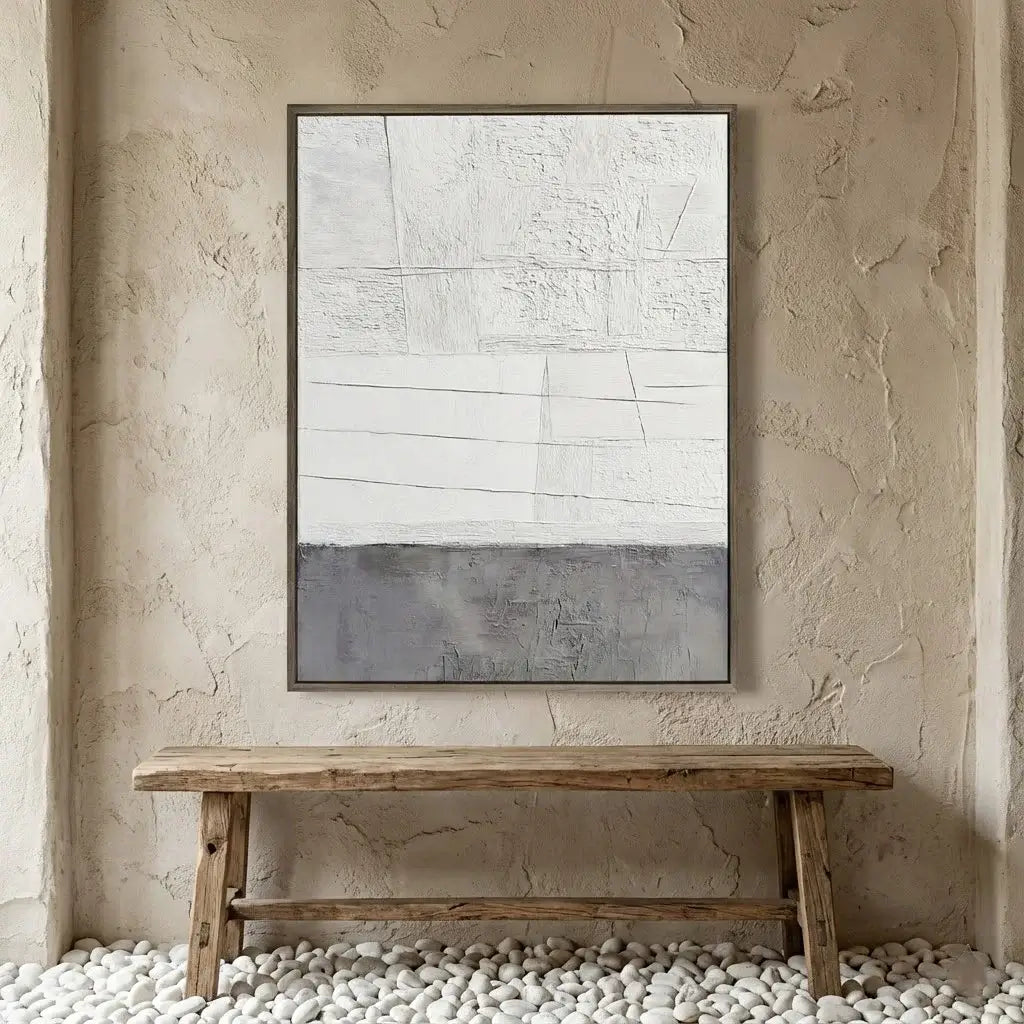 Abstract painting on a textured wall above a wooden bench.