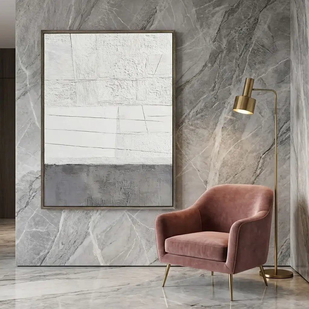 Pink armchair in a room with marble walls, abstract art, and a floor lamp.