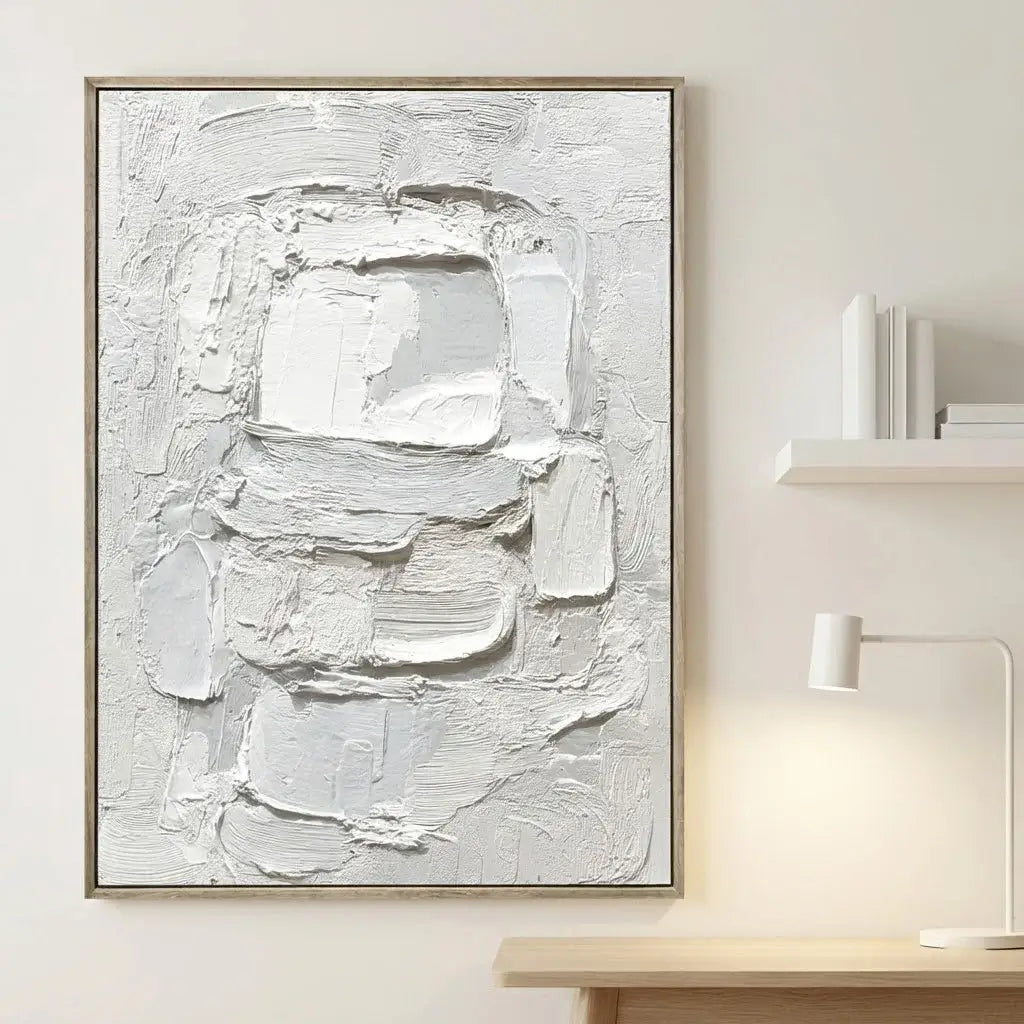 Abstract white painting on a light wall with a wooden frame