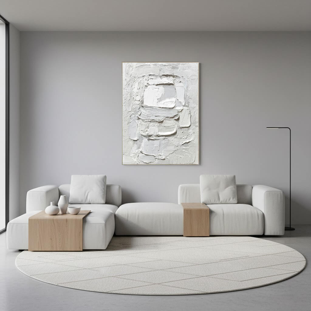 Modern living room with a gray sofa, abstract painting, and round rug.