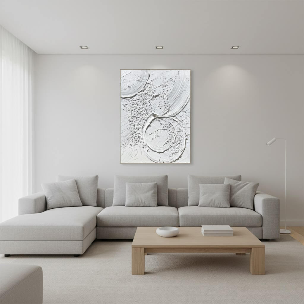 Modern living room with a gray sectional sofa, wooden coffee table, and abstract artwork on the wall.