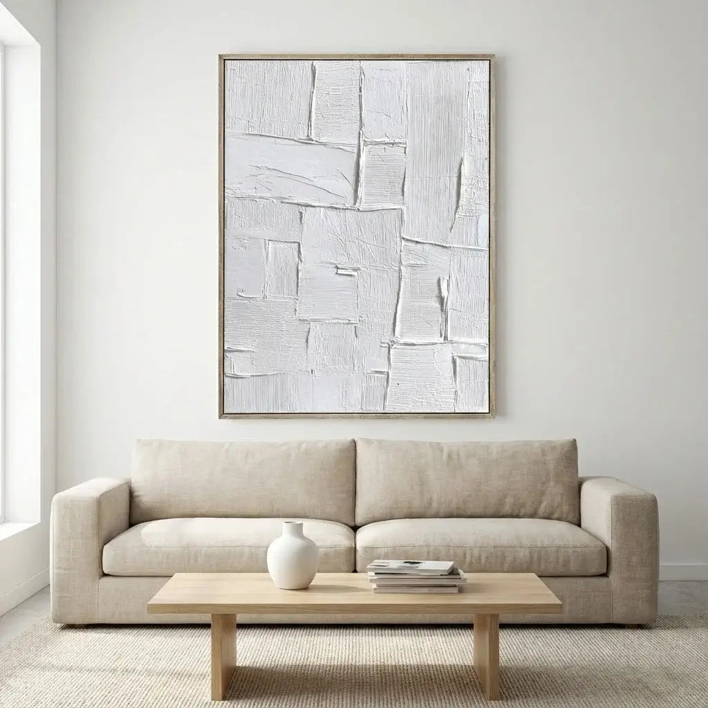 Beige sofa in a living room with abstract art on the wall