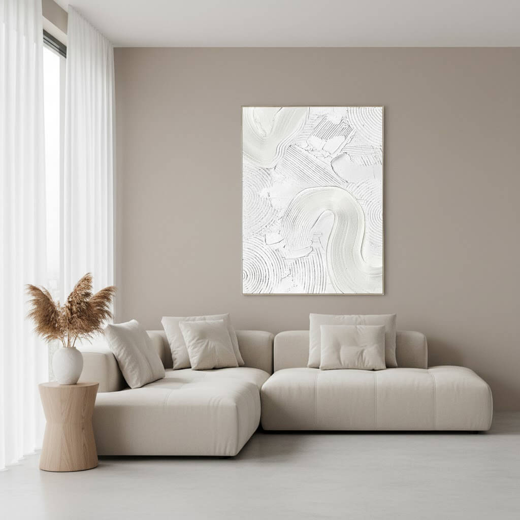 Modern living room with a beige sectional sofa, abstract artwork, and decorative elements.