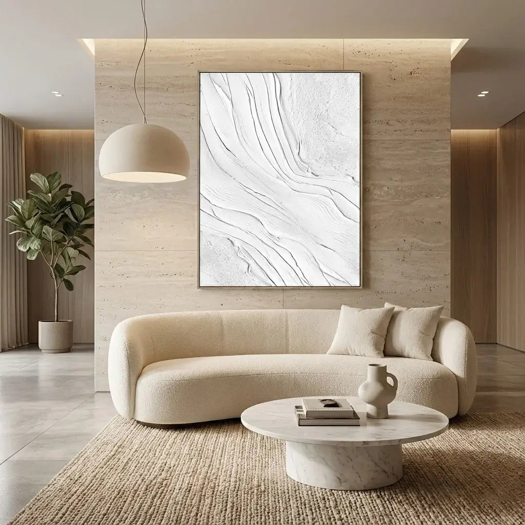 Modern living room with a beige sofa, abstract painting, and marble coffee table.