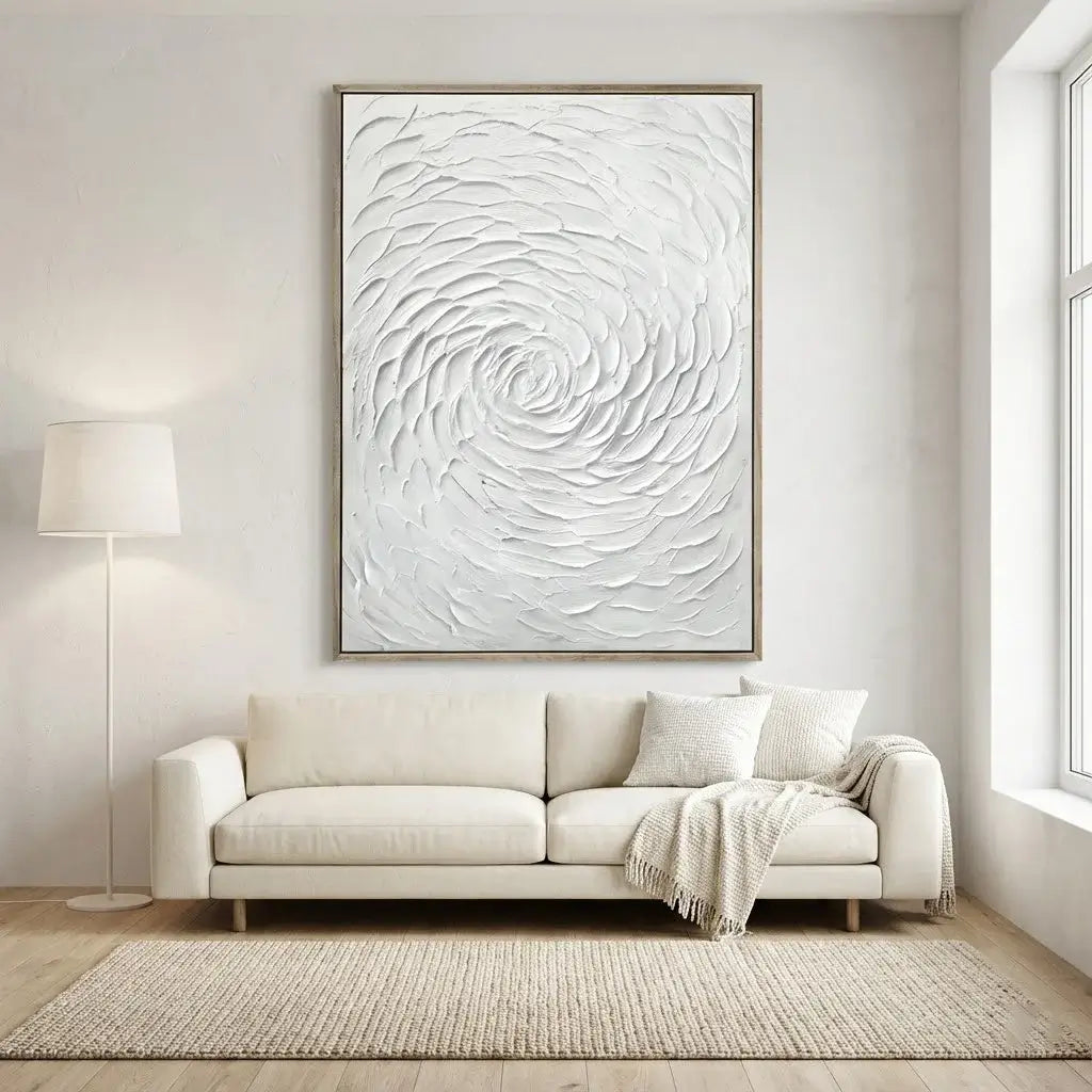 Modern living room with a white sofa, abstract wall art, and a lamp.