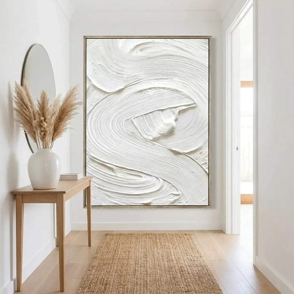 Modern interior with abstract artwork, vase with pampas grass, and wooden side table.