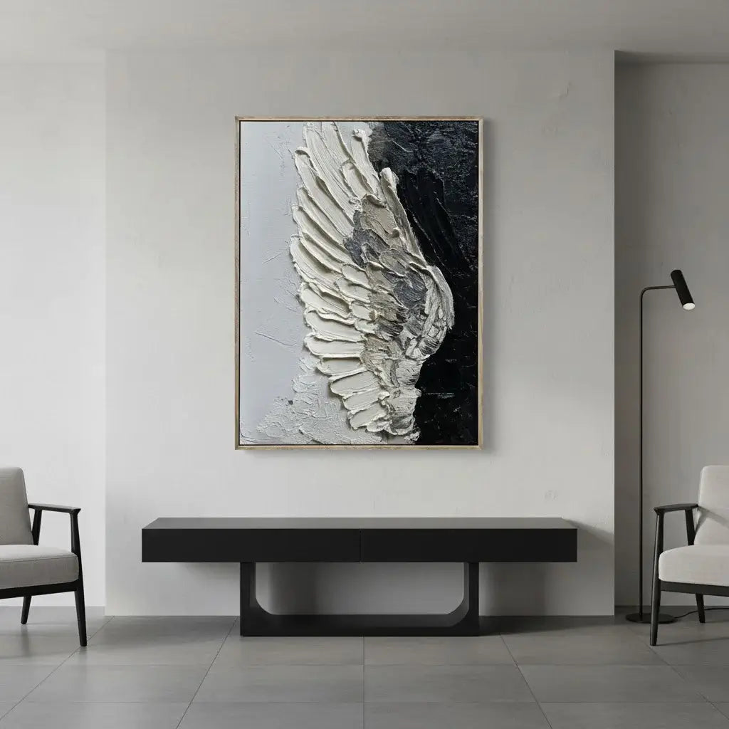 Modern interior with a large abstract painting of a wing on a wall, a black console table, and two chairs.
