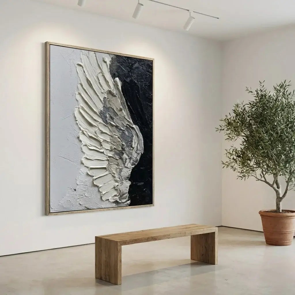Large abstract wing painting on a wall in a room with a wooden bench and potted plant.