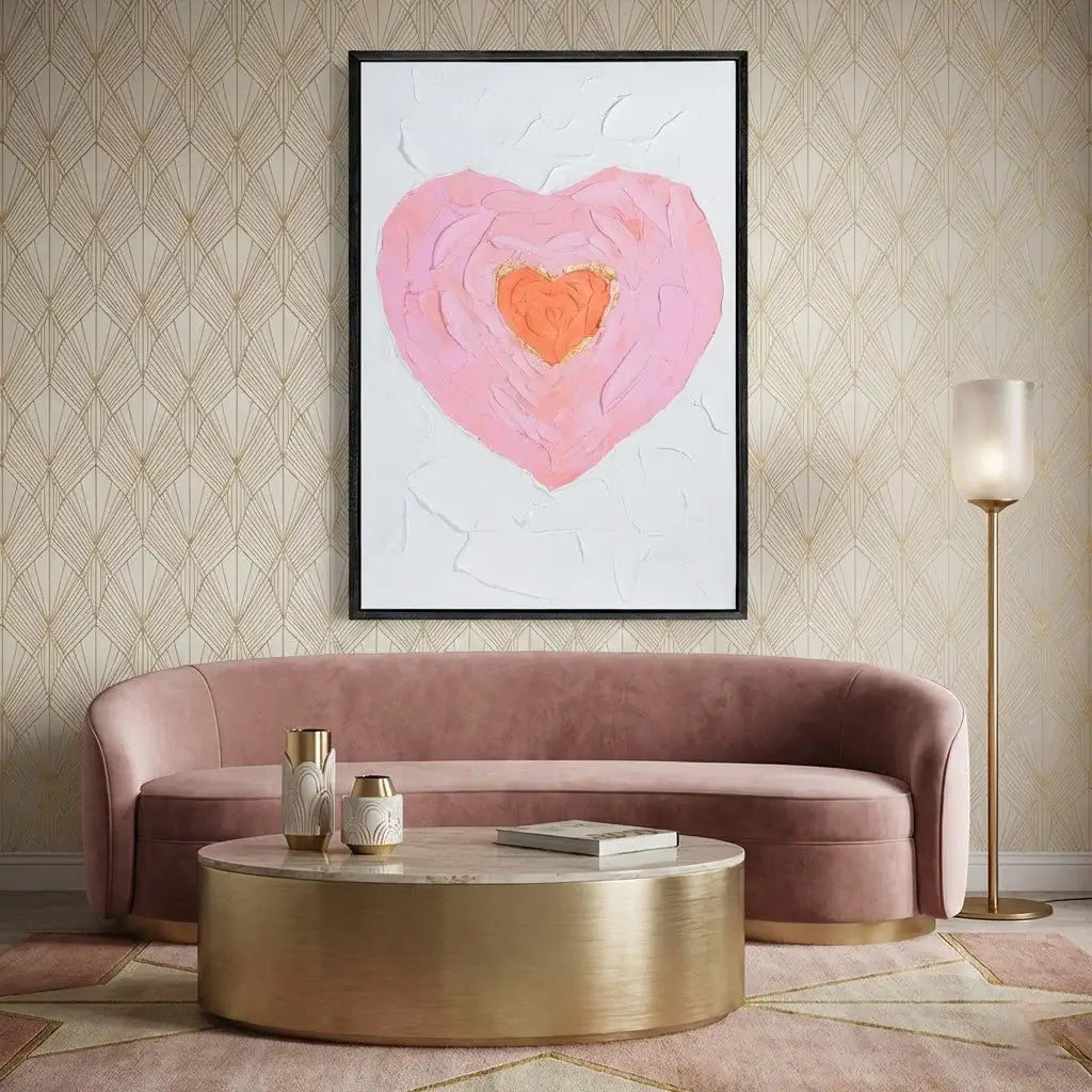 Living room with pink sofa, gold coffee table, and abstract heart artwork on wall.