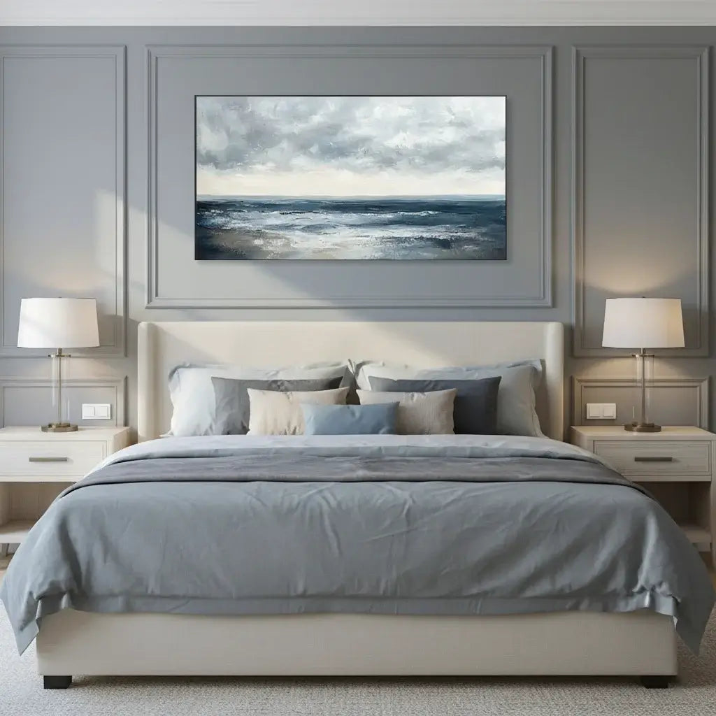 Modern bedroom with gray walls, a bed with gray bedding, and a framed artwork of a landscape.