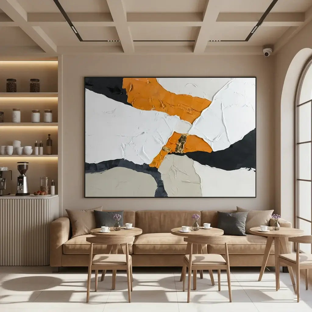 Modern living room with a large abstract painting on the wall, a beige sofa, and wooden chairs.