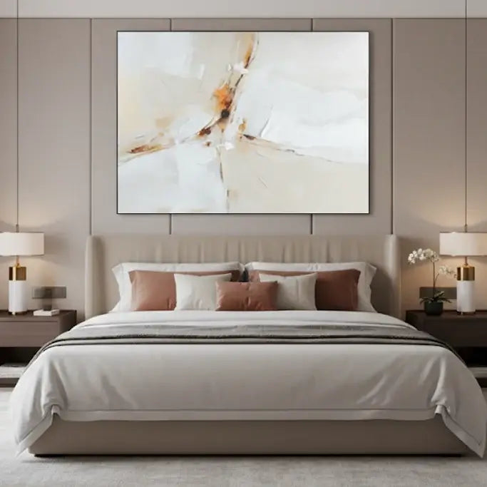 Modern bedroom with a bed, artwork on the wall, and side tables.