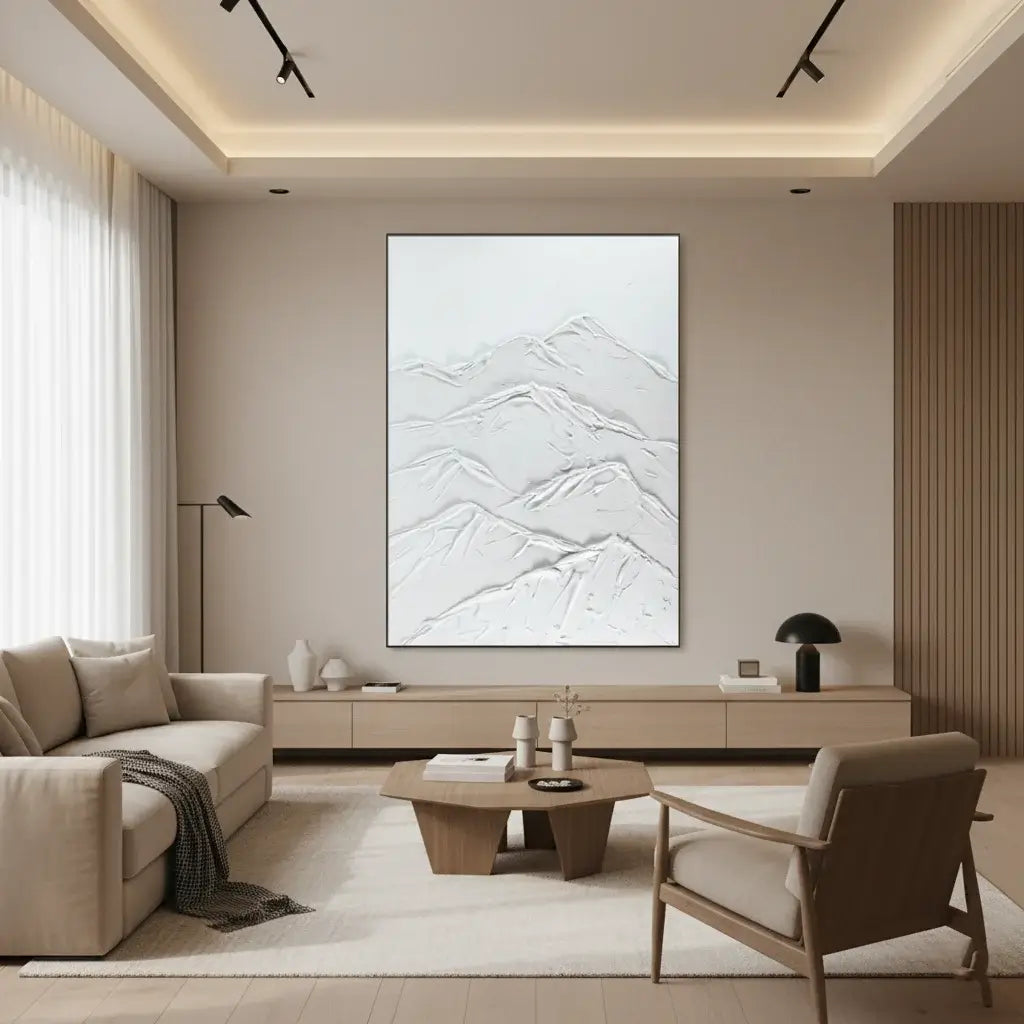 Modern living room with beige sofa, armchair, and coffee table, featuring a large abstract painting on the wall.