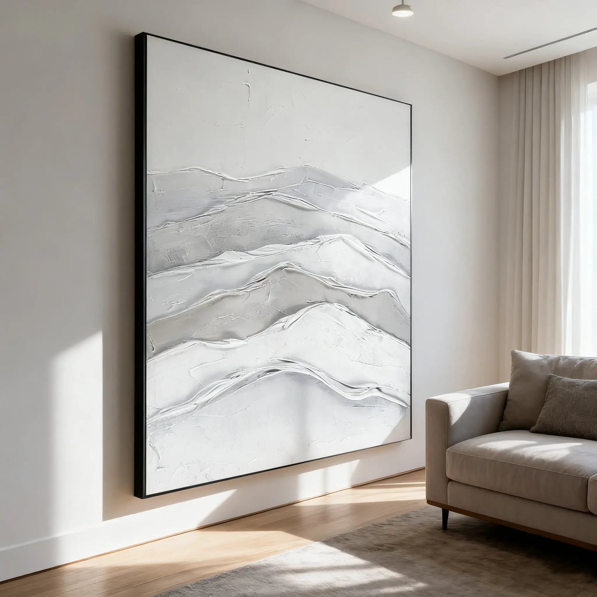 Abstract art piece on a wall in a modern living room with a sofa.
