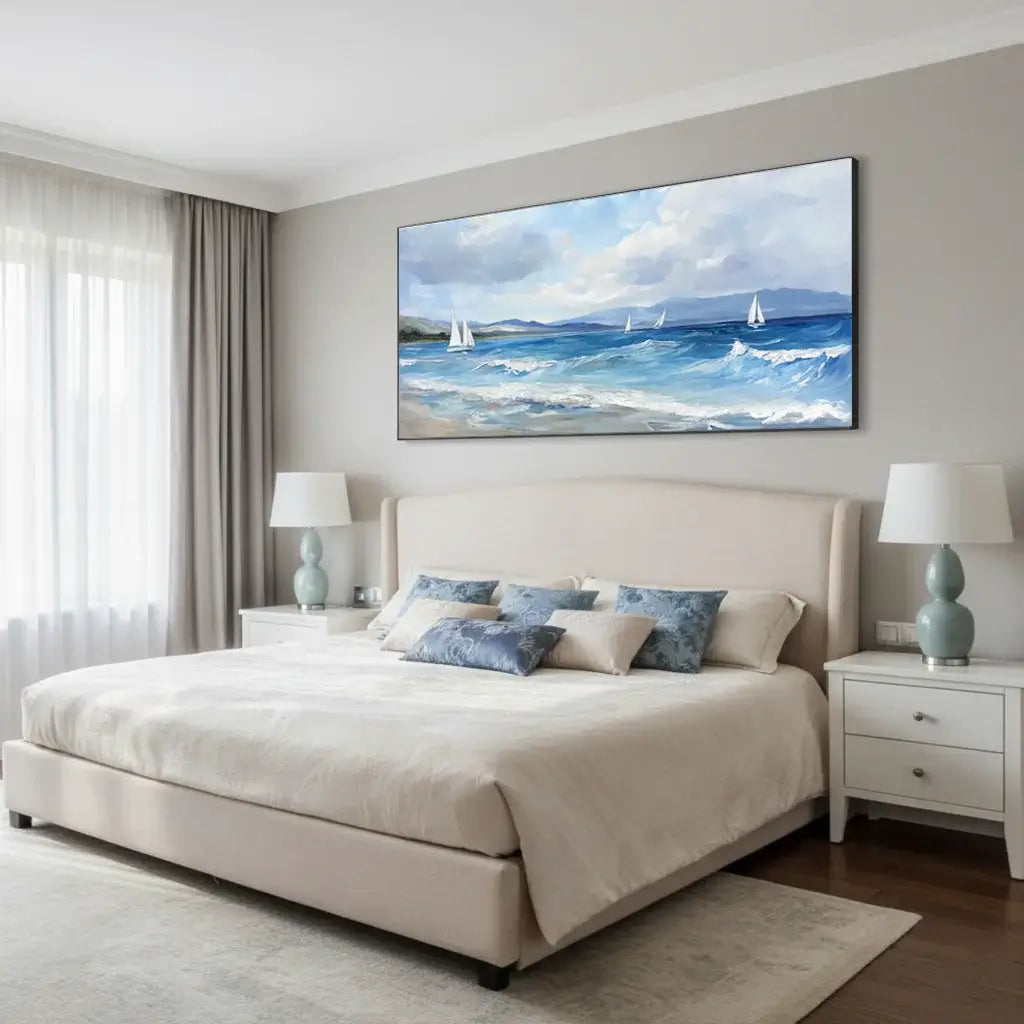 Modern bedroom with a large bed, side tables, and a wall painting of a seascape.