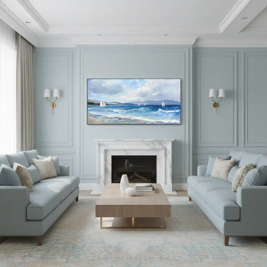 Modern living room with light gray walls, gray sofas, a coffee table, and a beach scene oil painting.