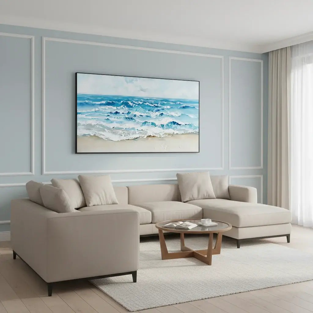 Modern living room with a beige sectional sofa, coffee table, and beach-themed wall art.
