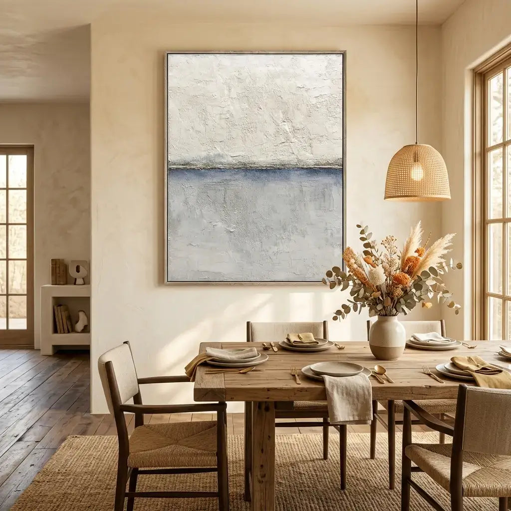 Dining room with wooden table, chairs, abstract painting, and decorative elements.