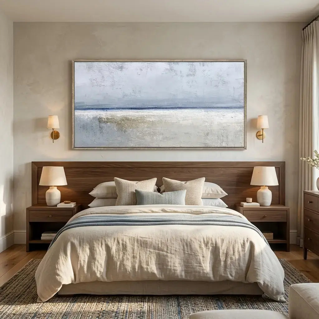 Modern bedroom with a large bed, wooden headboard, and wall art.