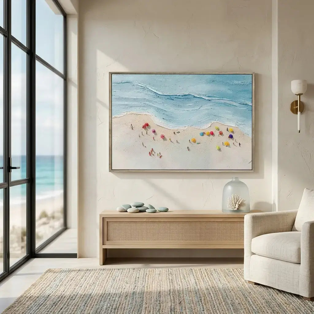 Modern living room with a beach-themed painting on the wall, large windows, and a beige armchair.