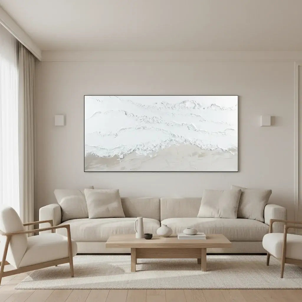 Modern living room with a beige sofa, armchair, and abstract painting on the wall.