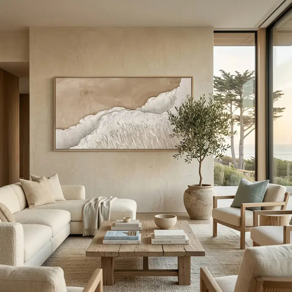 Modern living room with neutral tones, a large abstract painting, and a view of trees outside.