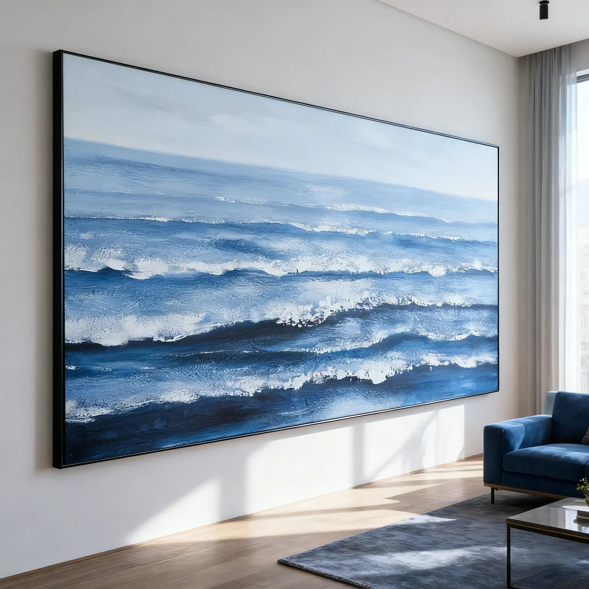Large painting of ocean waves in a modern living room.